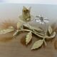 Pair of gilded metal candle holders and tassels