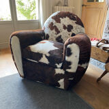 Pair of club chairs covered in cowhide