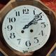 Old round porthole bull's eye wall clock in its wooden case + pendulum + key