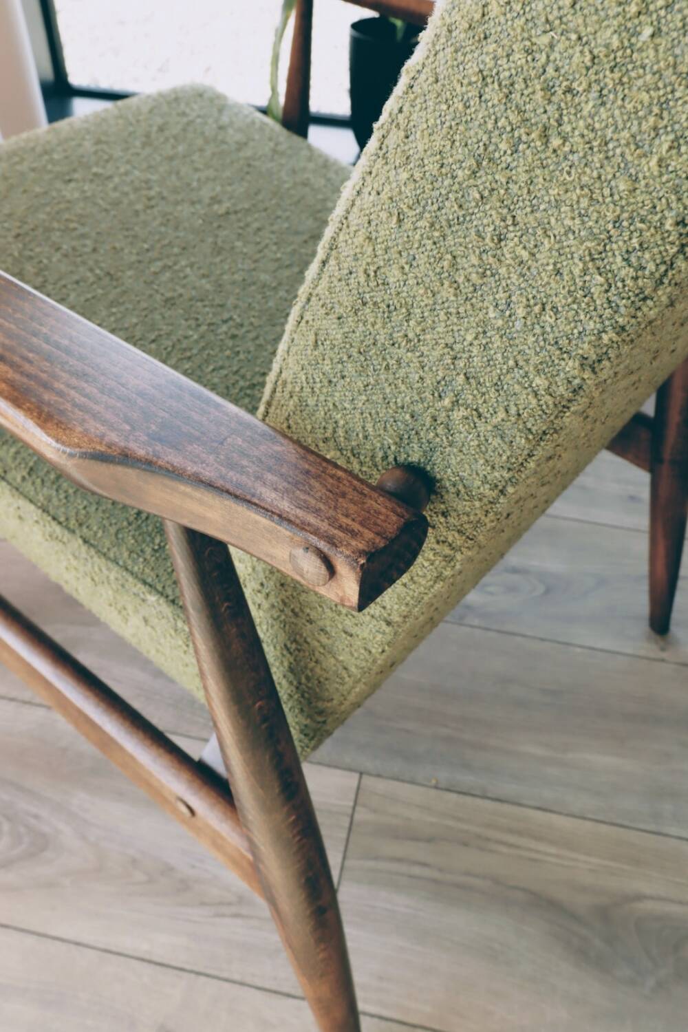 Mid-century modern armchair in olive green bouclé design by H. Lis.