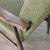 Mid-century modern armchair in olive green bouclé design by H. Lis.