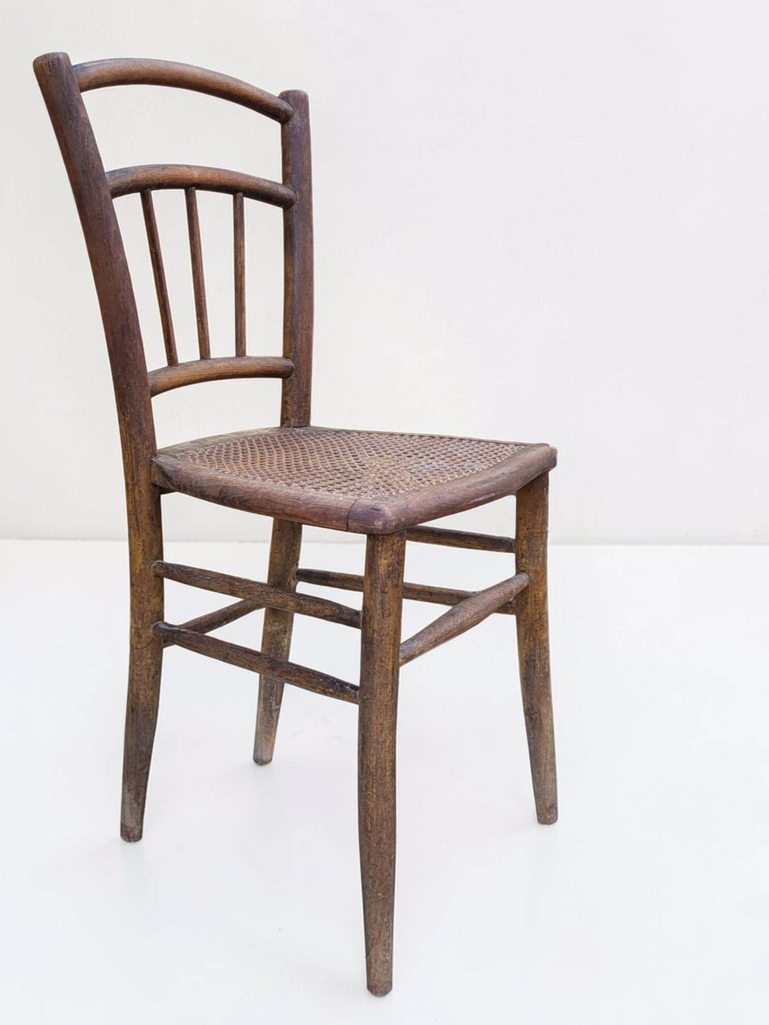 Chair with a slatted backrest and caned seat.