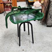 Vintage swivel workshop chair in green pressed sheet metal with a folding backrest.