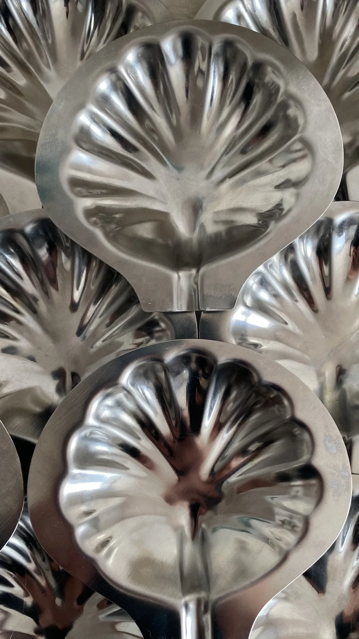 Set of 12 stainless steel scallop shells, 1970s-80s.