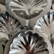 Set of 12 stainless steel scallop shells, 1970s-80s.