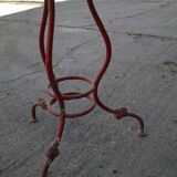 Vintage red cast iron bistro table (1950s) — round metal top, tripod base.