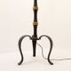 Tripod floor lamp in wrought iron and brass with bamboo-style base.