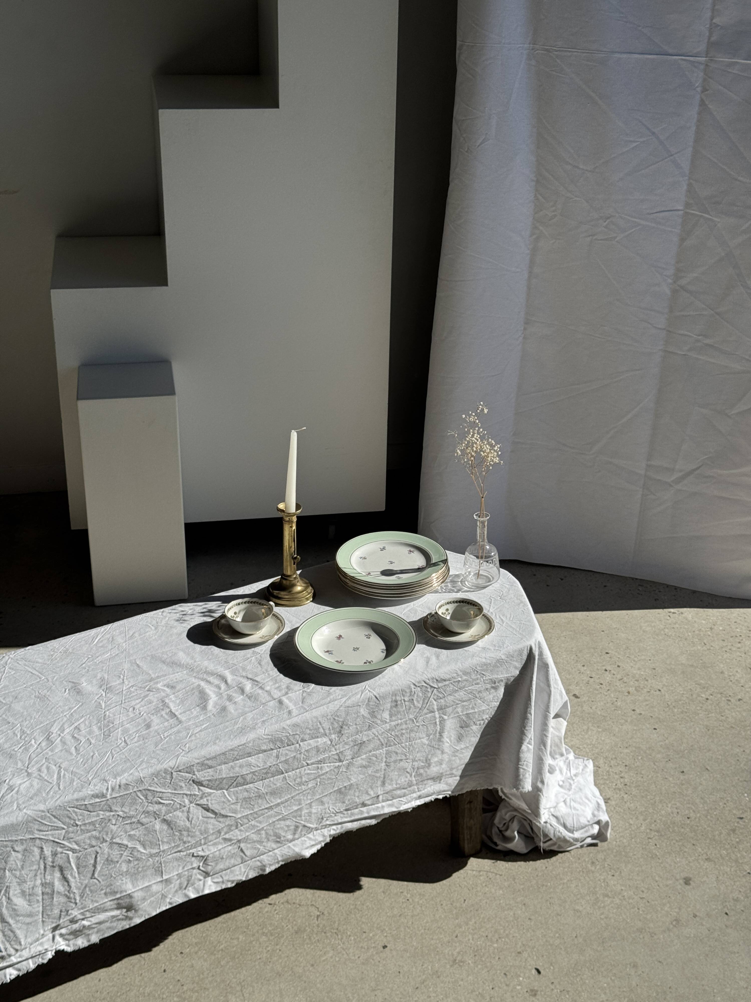 Set of 9 vintage turquoise deep plates with gold trim and pink flowers.