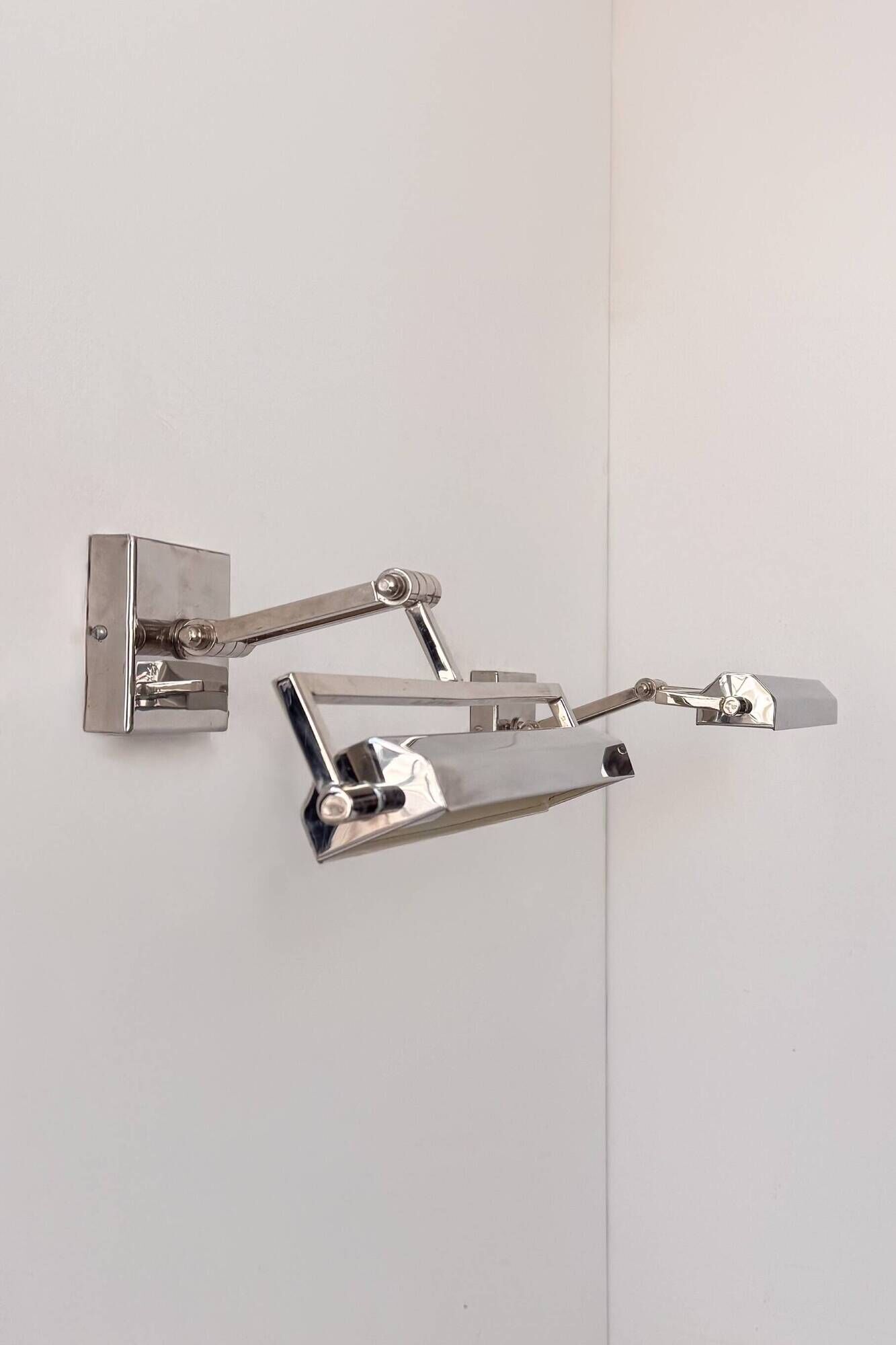 Pair of vintage geometric adjustable wall lights in chrome metal, France 70s.