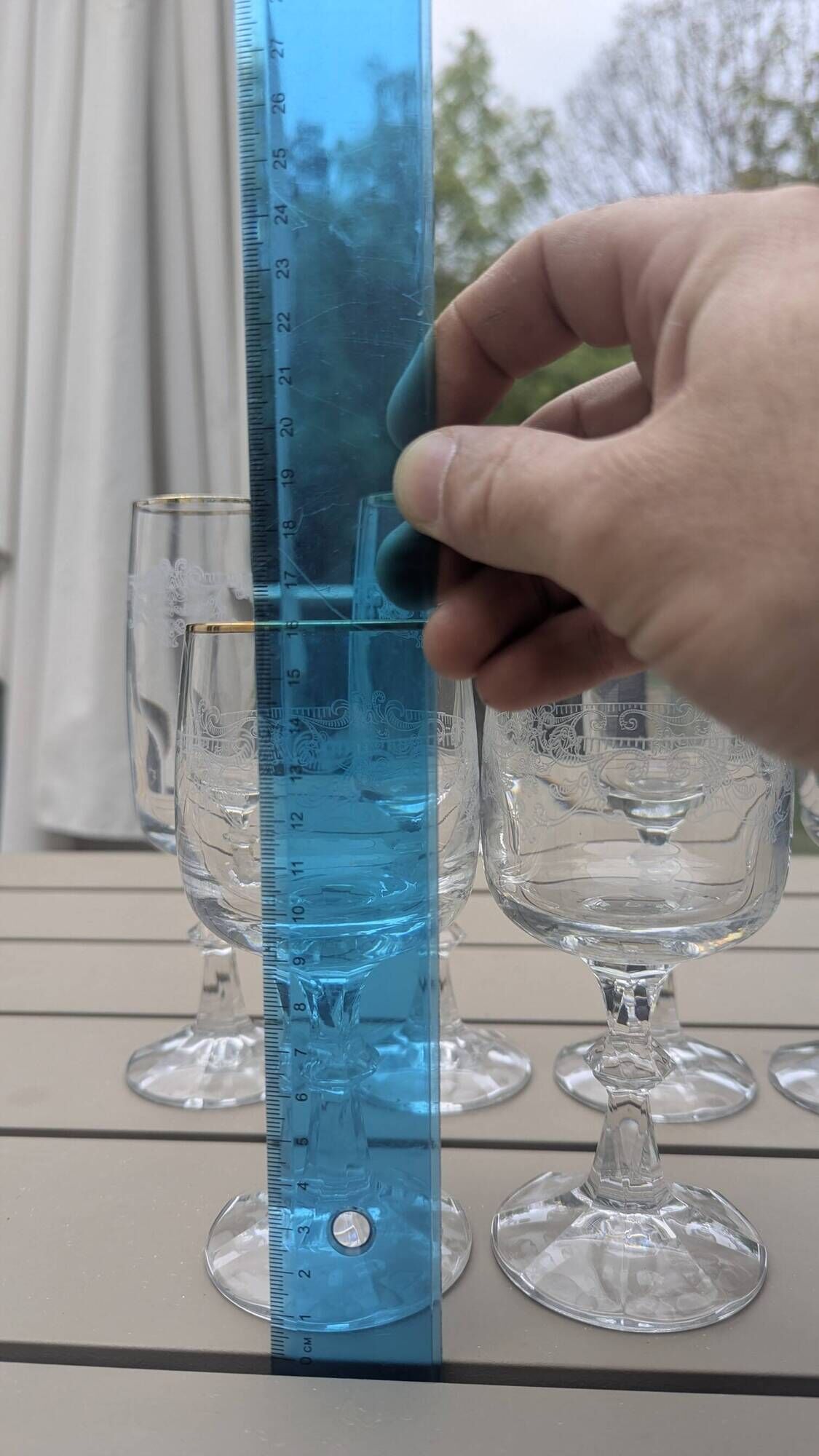 Set of 15 engraved crystal glasses with a gold rim.