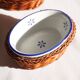 Set of 4 white porcelain dishes with blue decorations and wicker stands