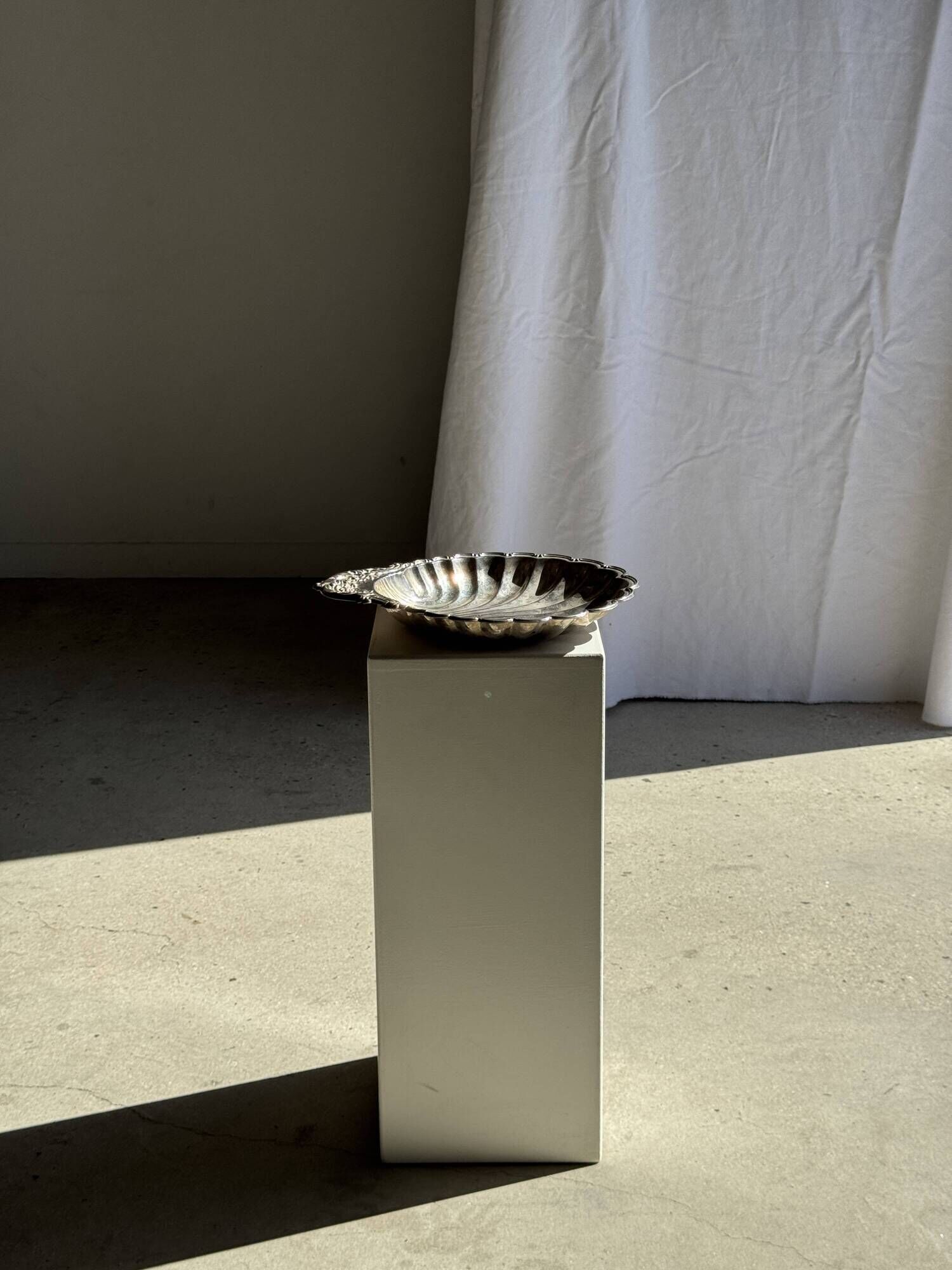 Large antique silver-plated bowl in the shape of a shell.