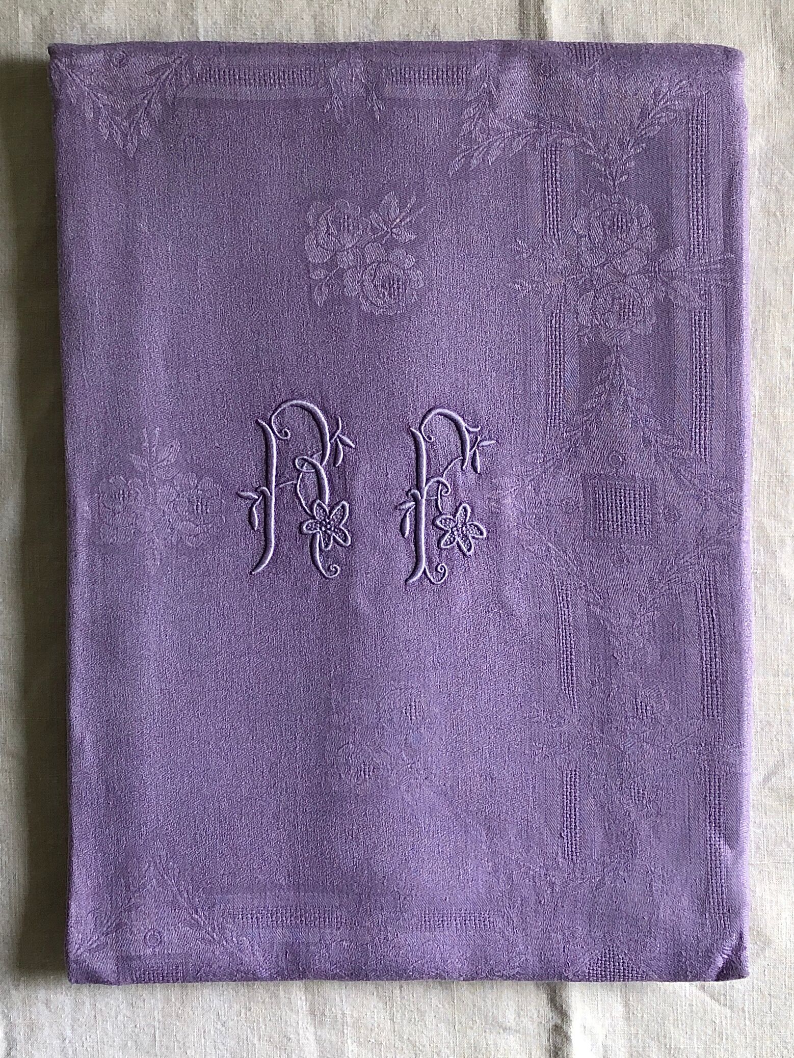 Old damask tablecloth in linen and purple silk