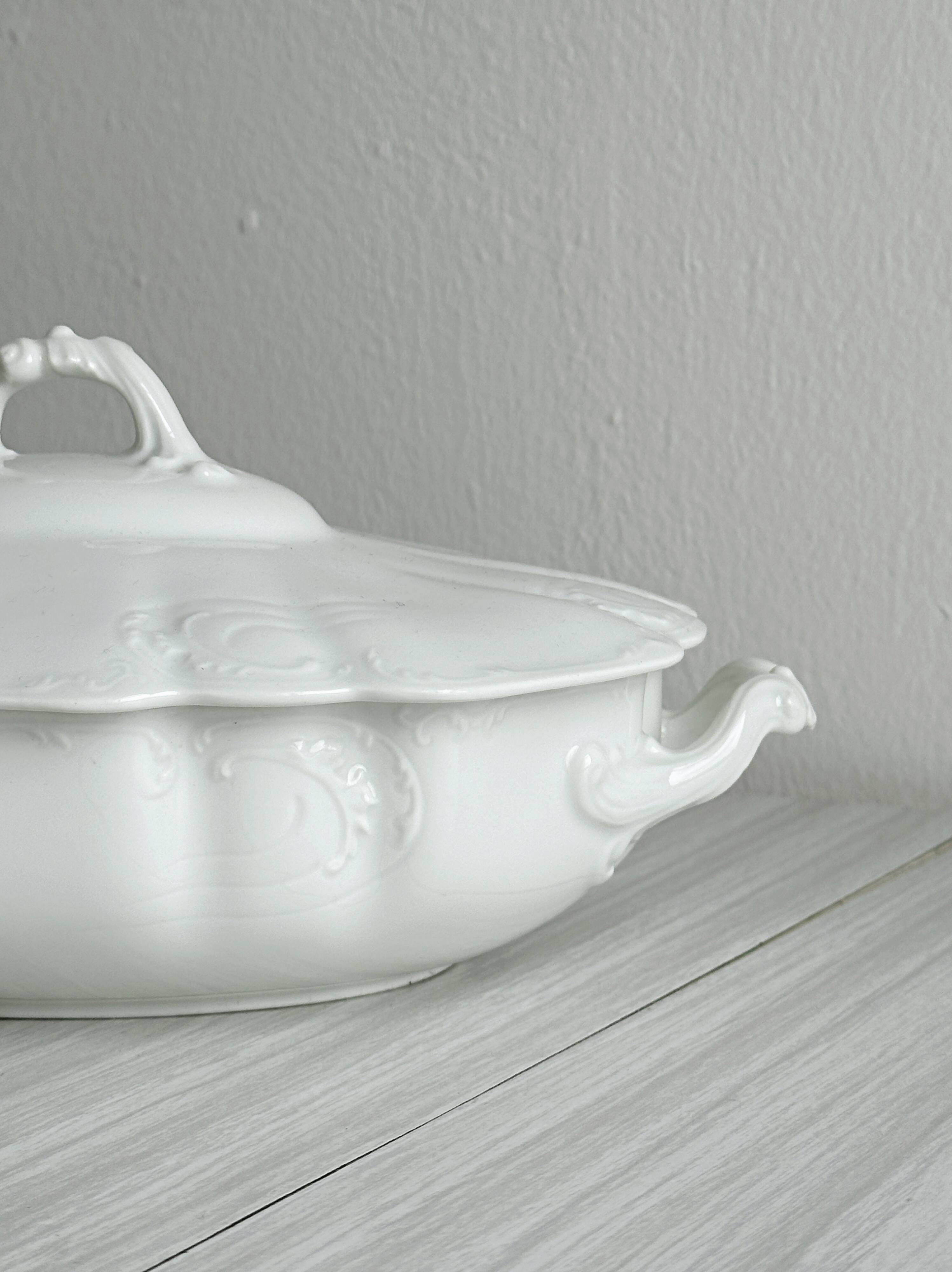 White fine porcelain soup tureen with relief decoration.