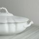 White fine porcelain soup tureen with relief decoration.