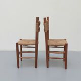 Pair of wooden chairs with seat and straw back