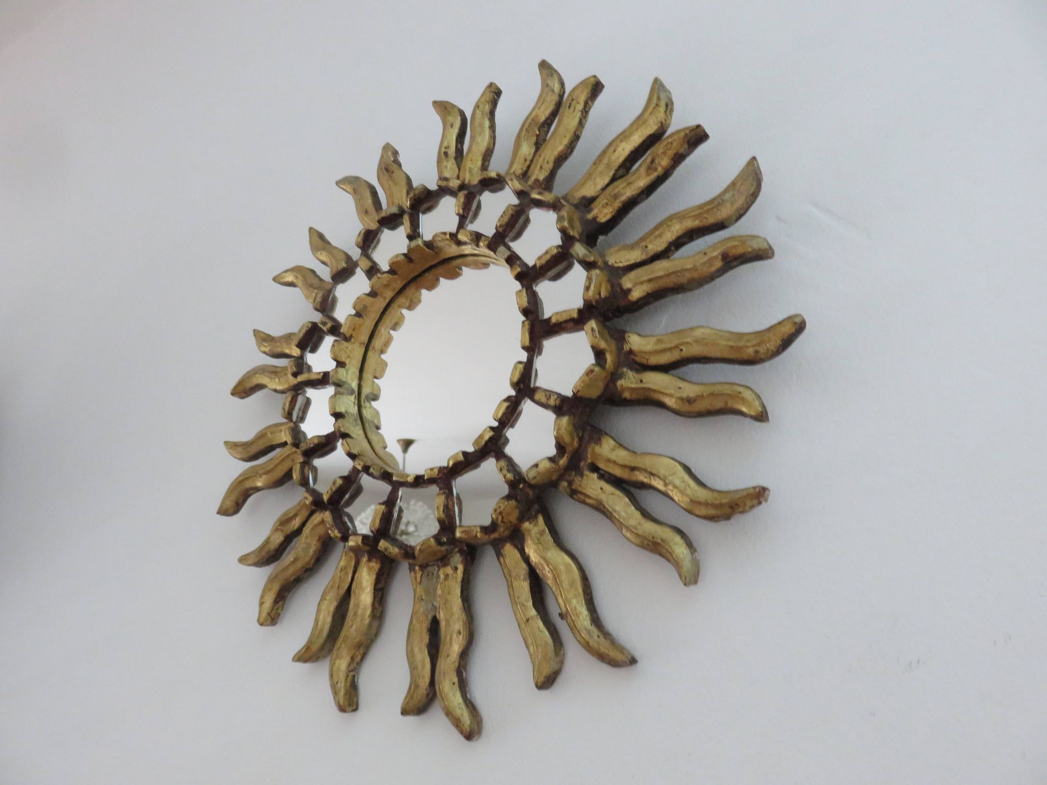 Golden wooden sun mirror with inlays from the early 20th century.