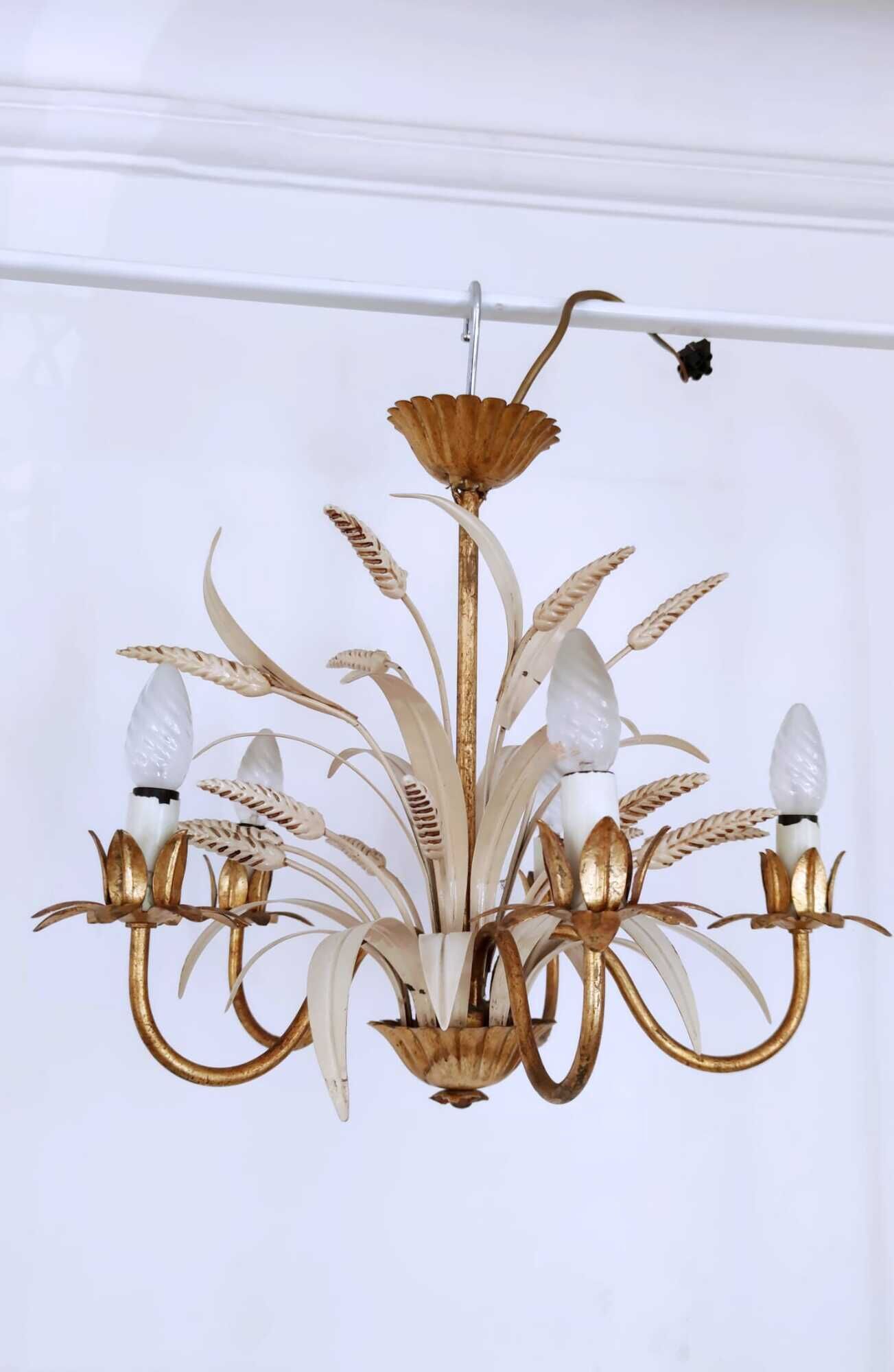 Vintage wrought iron chandelier decorated with golden and beige reeds