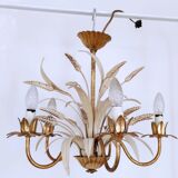Vintage wrought iron chandelier decorated with golden and beige reeds