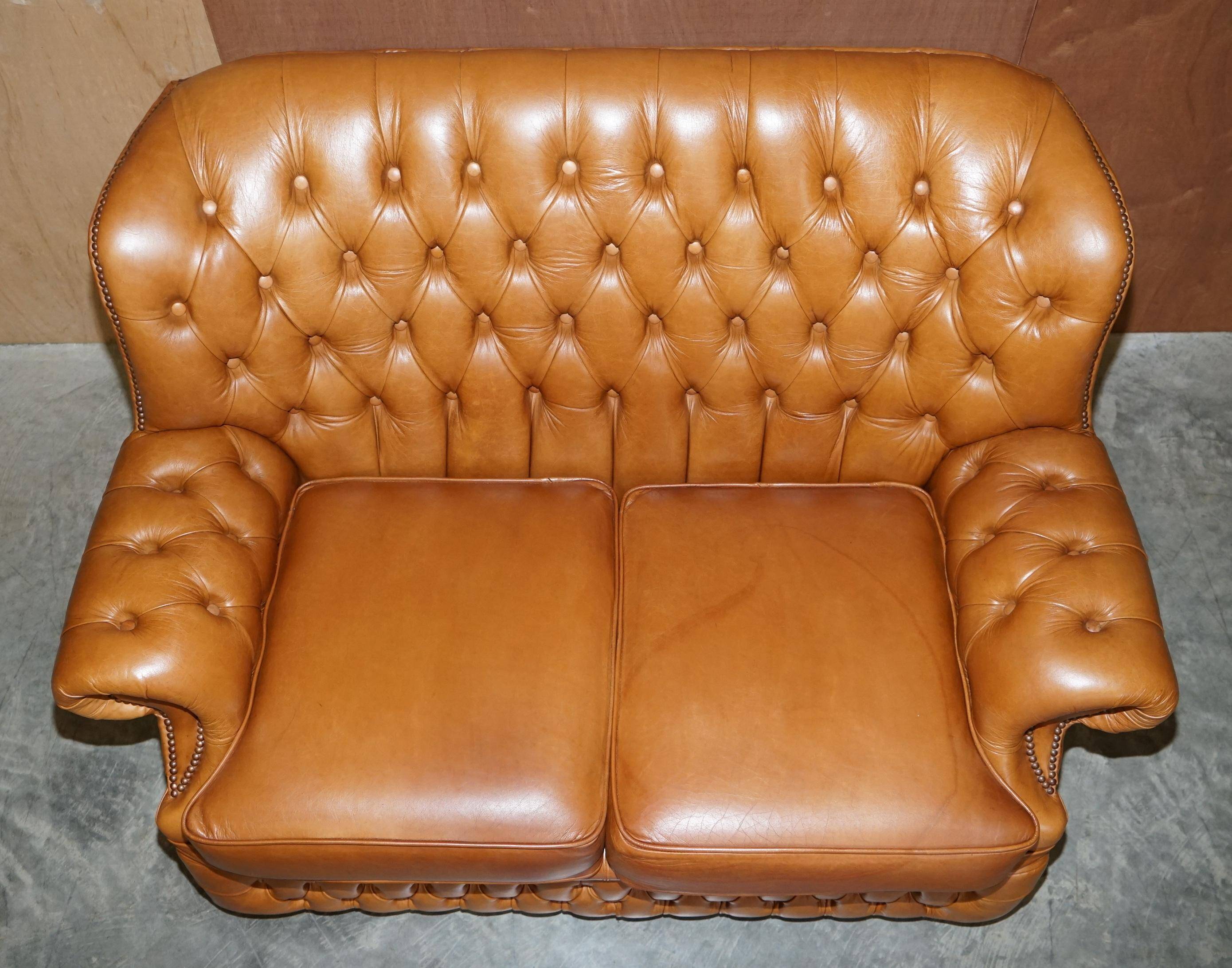 Small Chesterfield leather sofa with a high back.