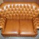 Small Chesterfield leather sofa with a high back.