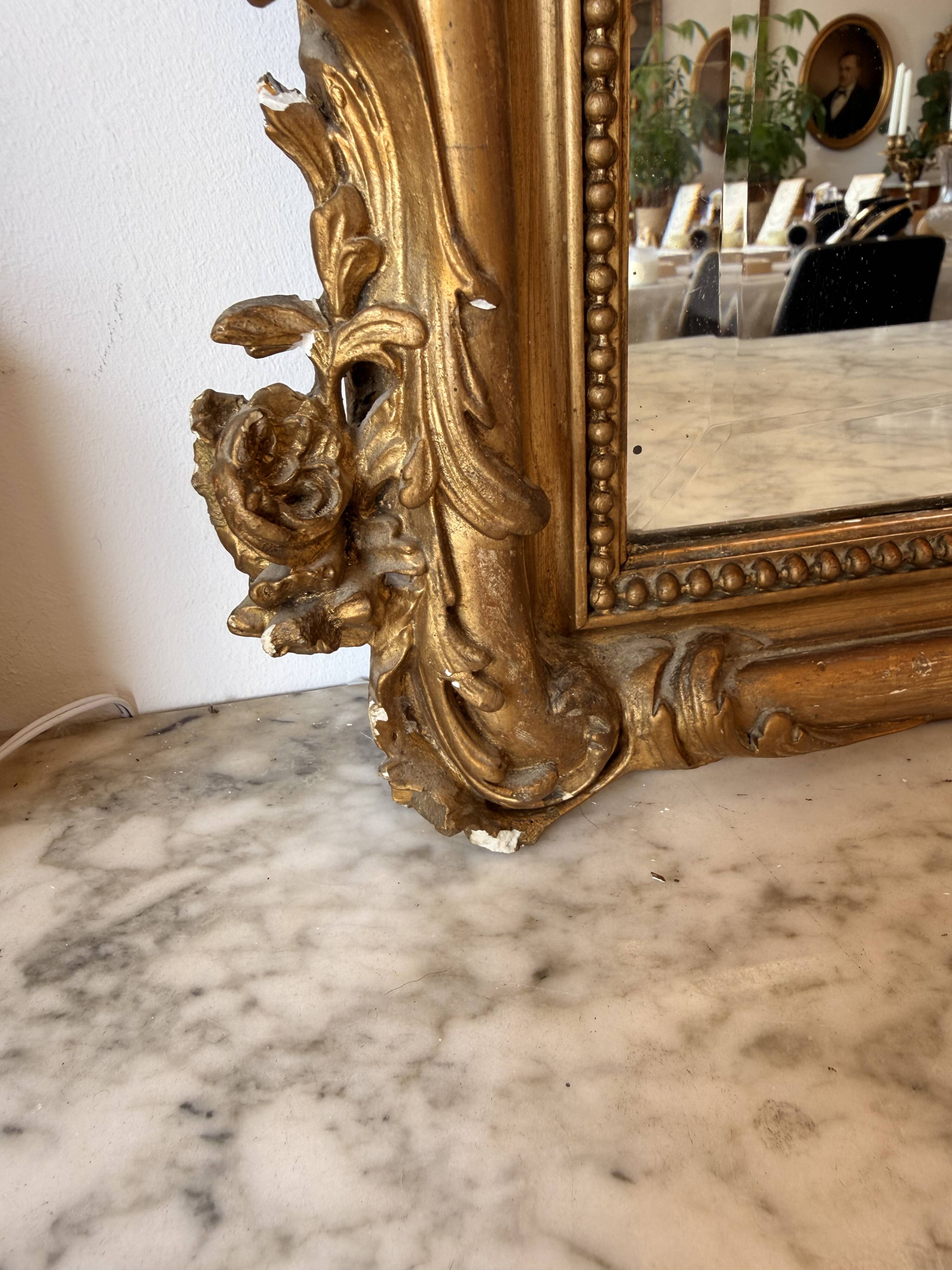 Large antique Louis XV style mirror in gilded wood.