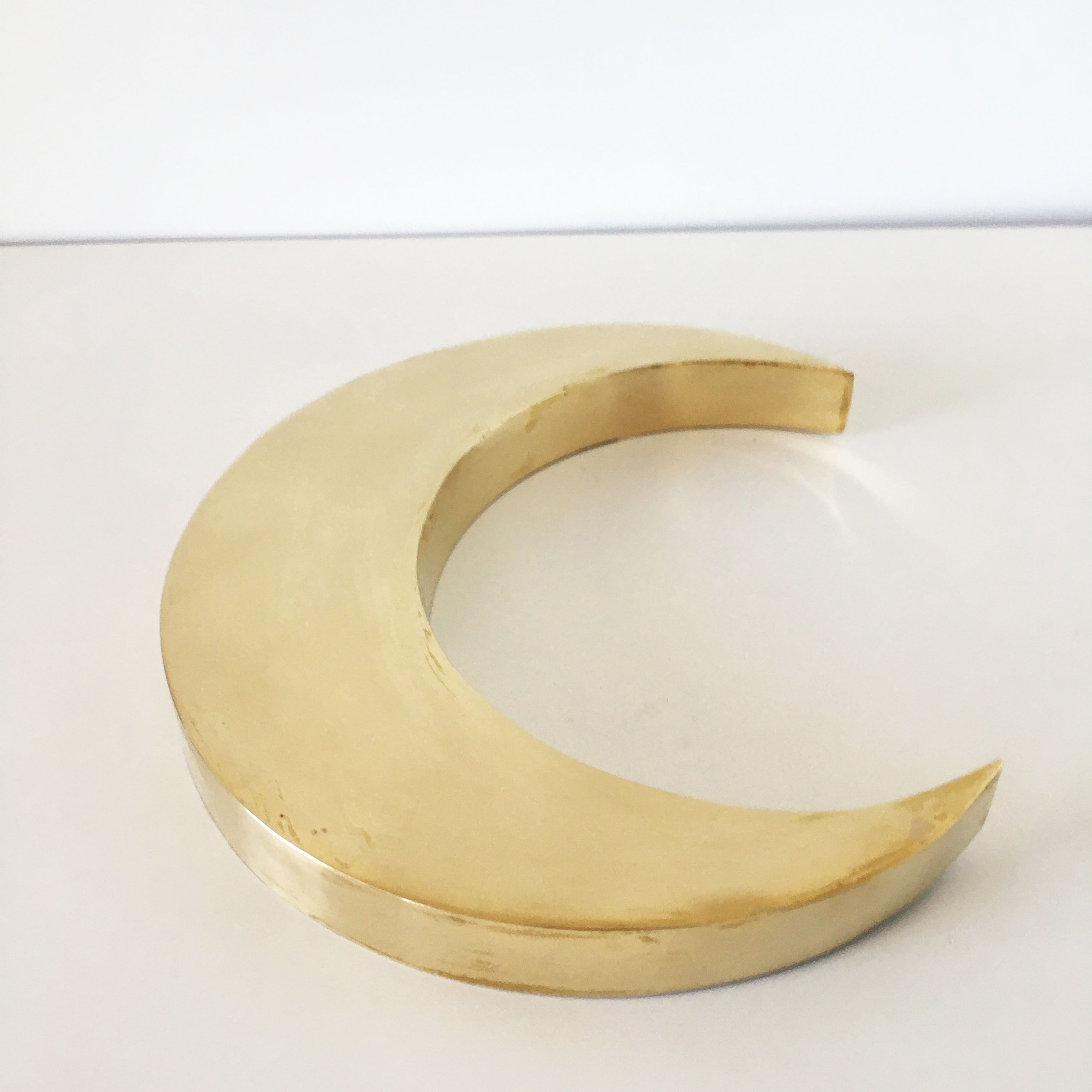 Moon or letter of sign "C" in vintage brass