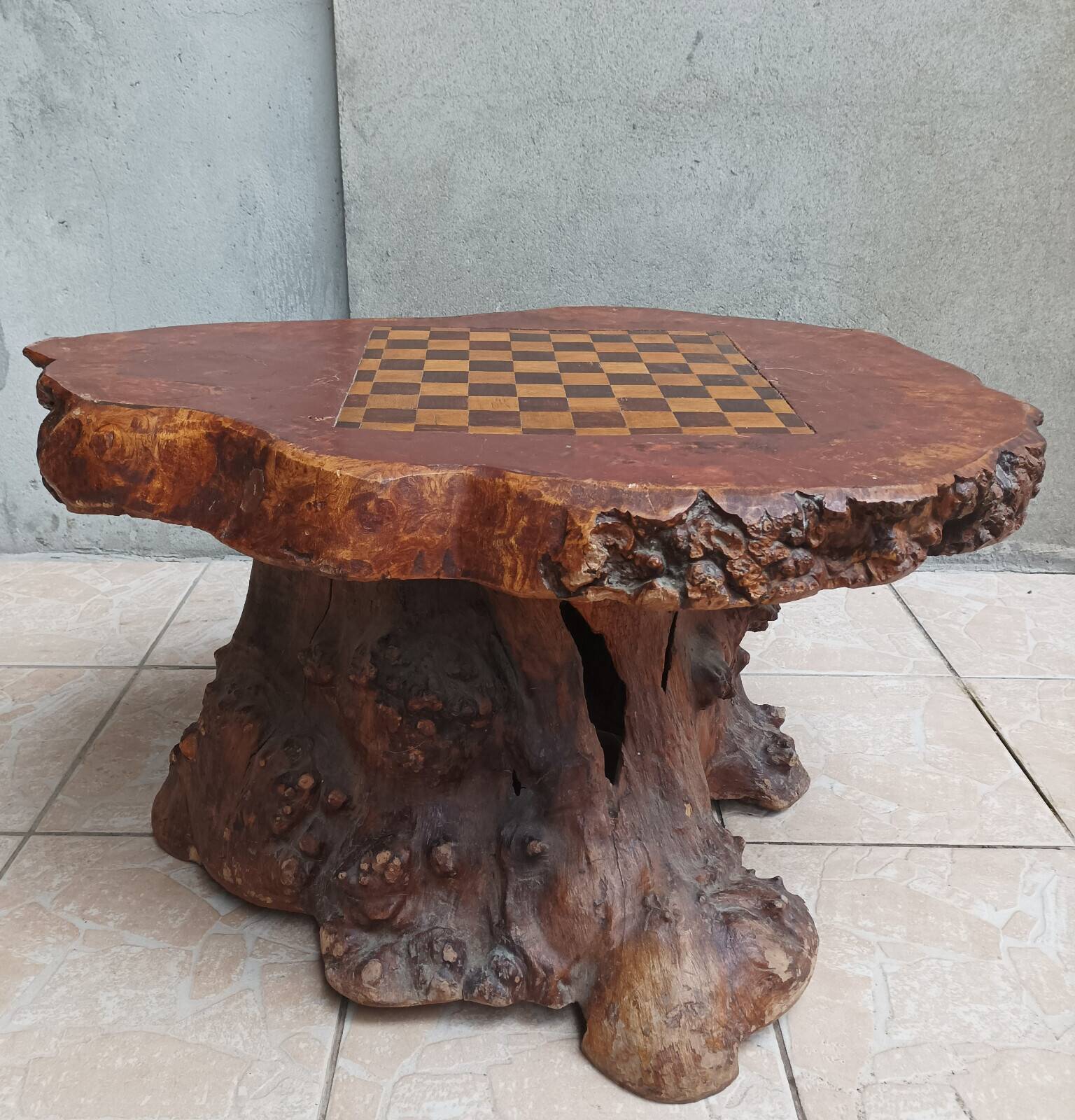 Brutalist chessboard coffee table made from tree stump.