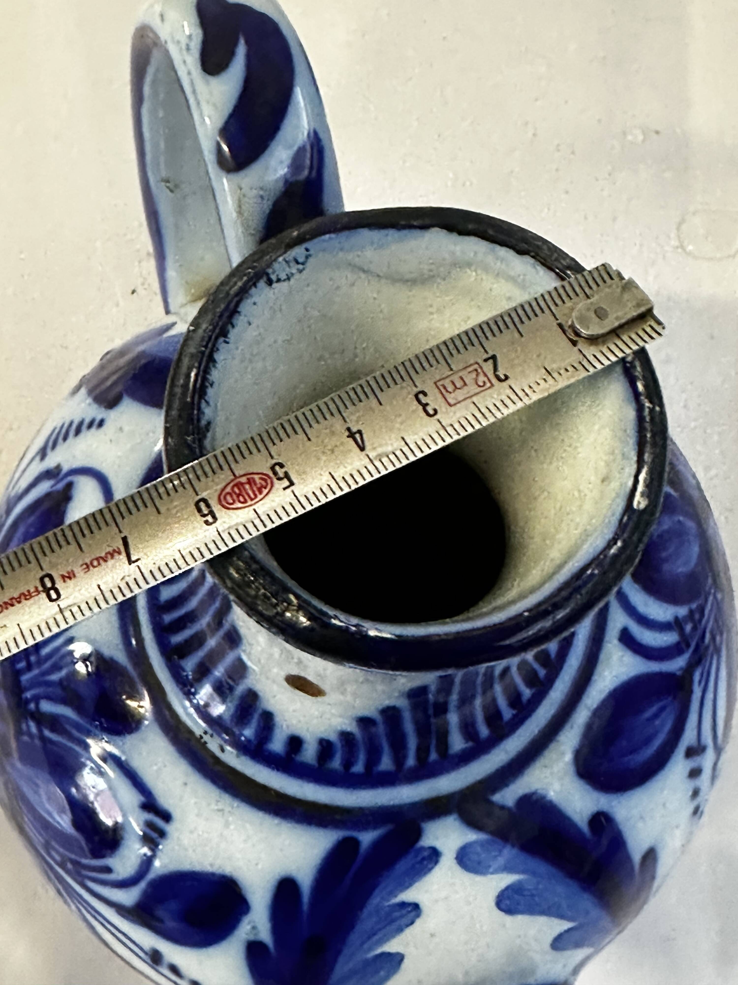Glazed ceramic carafe with floral decoration