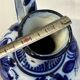 Glazed ceramic carafe with floral decoration