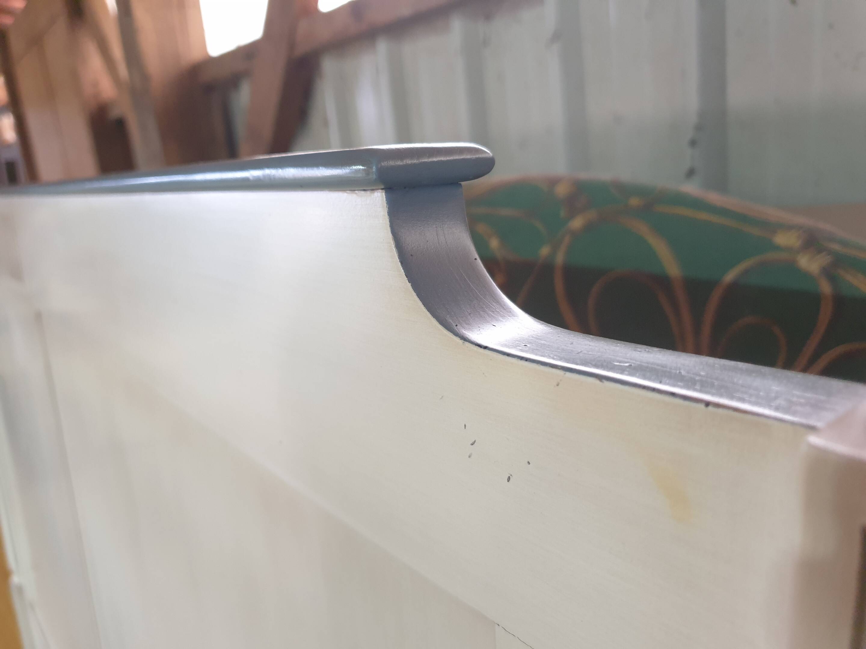 White headboard in Napoleon style with brass feet.