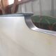 White headboard in Napoleon style with brass feet.