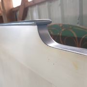White headboard in Napoleon style with brass feet.