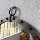 Brutalist round mirror with wrought iron and studs.