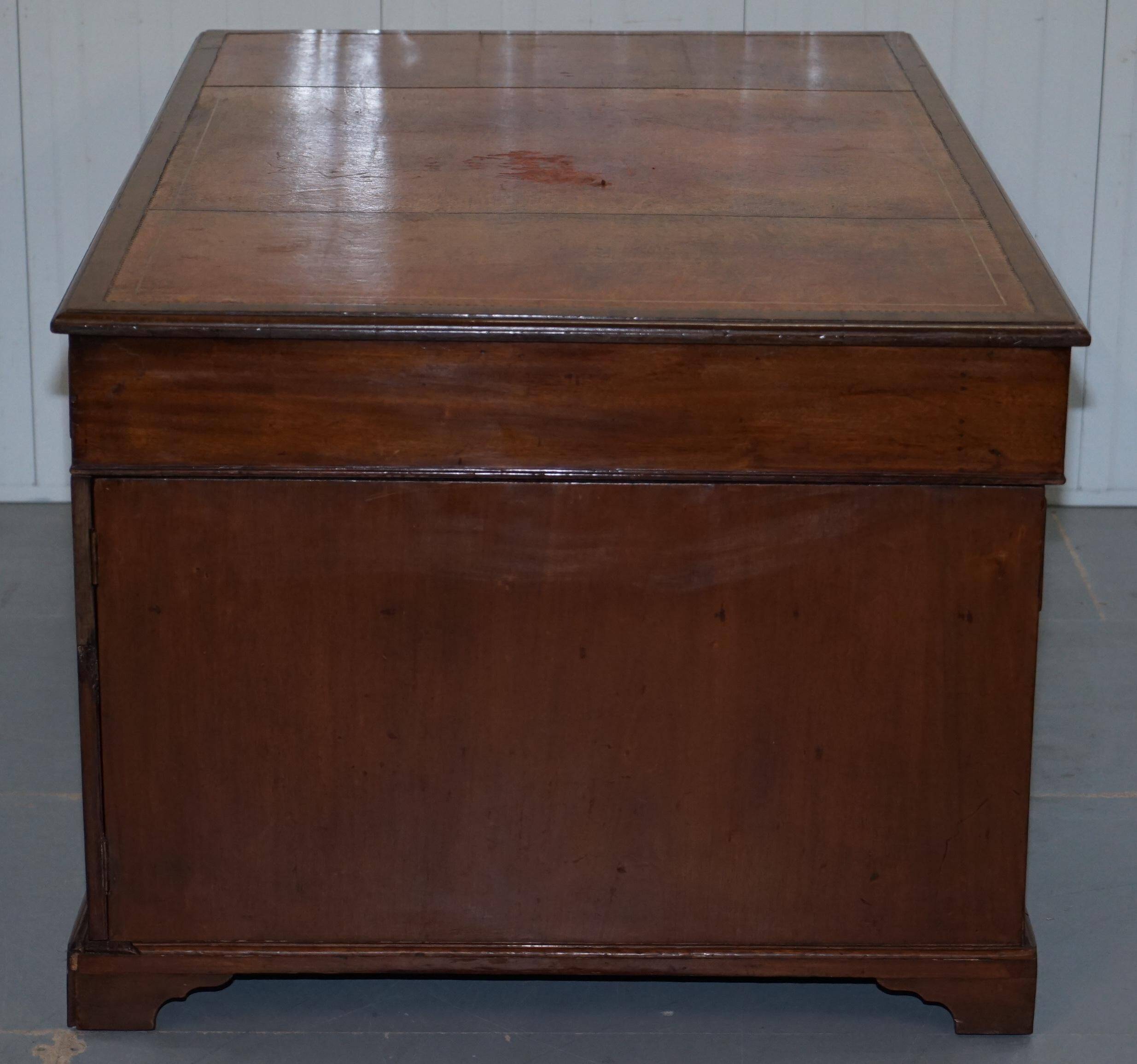 Double-sided partner's desk in walnut, George III, circa 1780, with lion head handles.