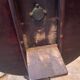 Foldable tripod side table in carved mahogany with brass trim.
