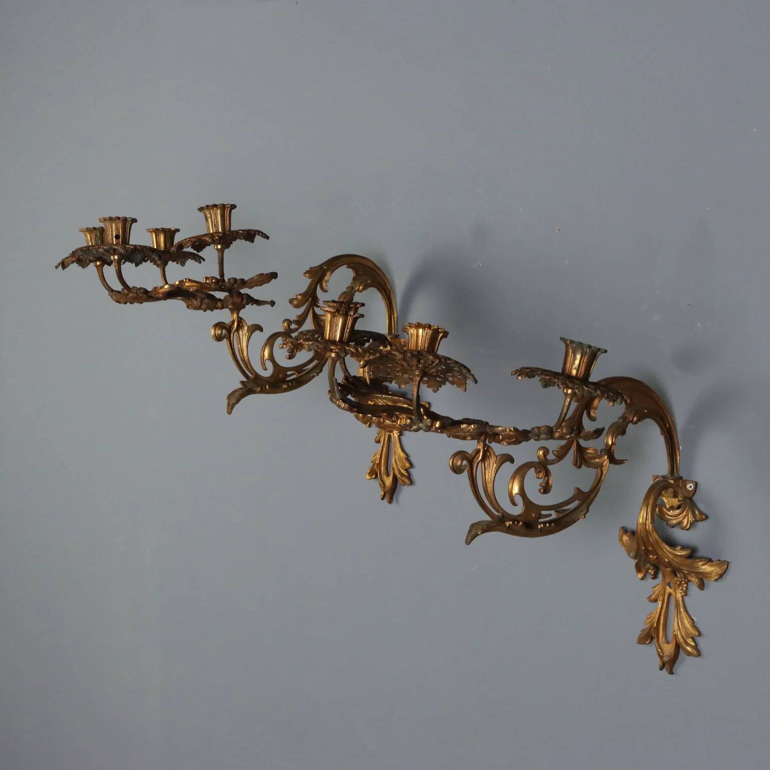Antique wall sconces in gilded bronze, 20th century, in baroque style.