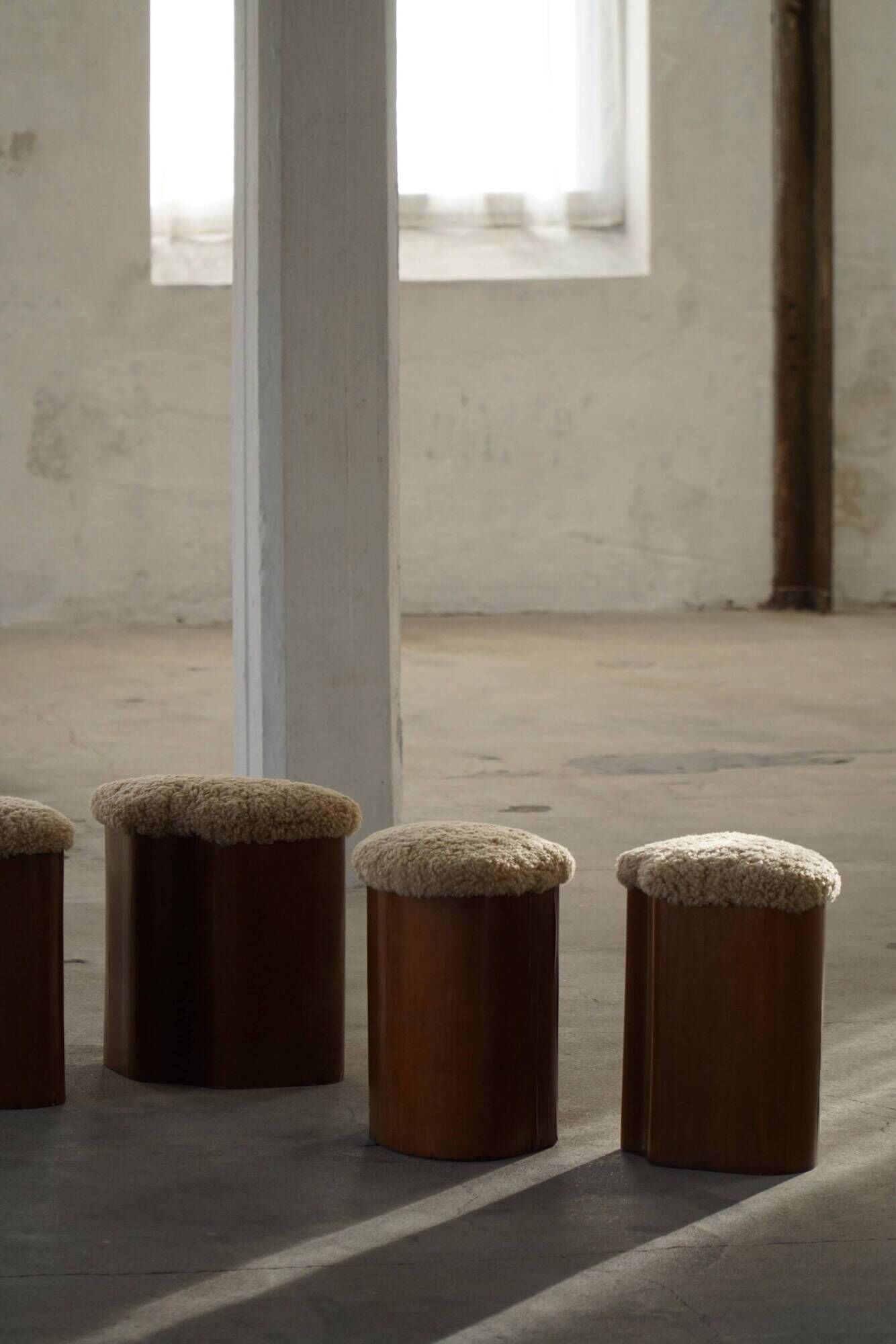 Set of 4 sculptural French Art Deco stools in wood and lamb's wool, 1940s.