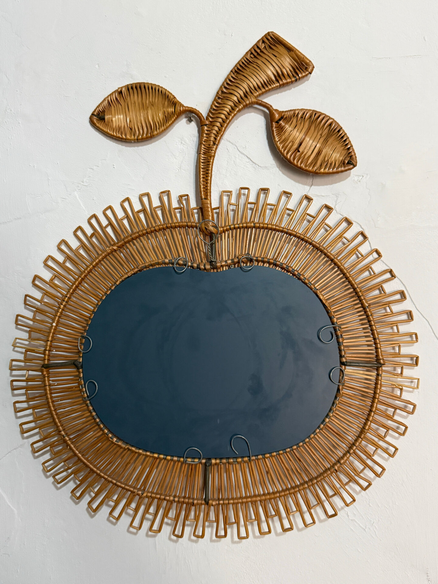 Rattan mirror in the shape of an apple from the 1960s Italy.