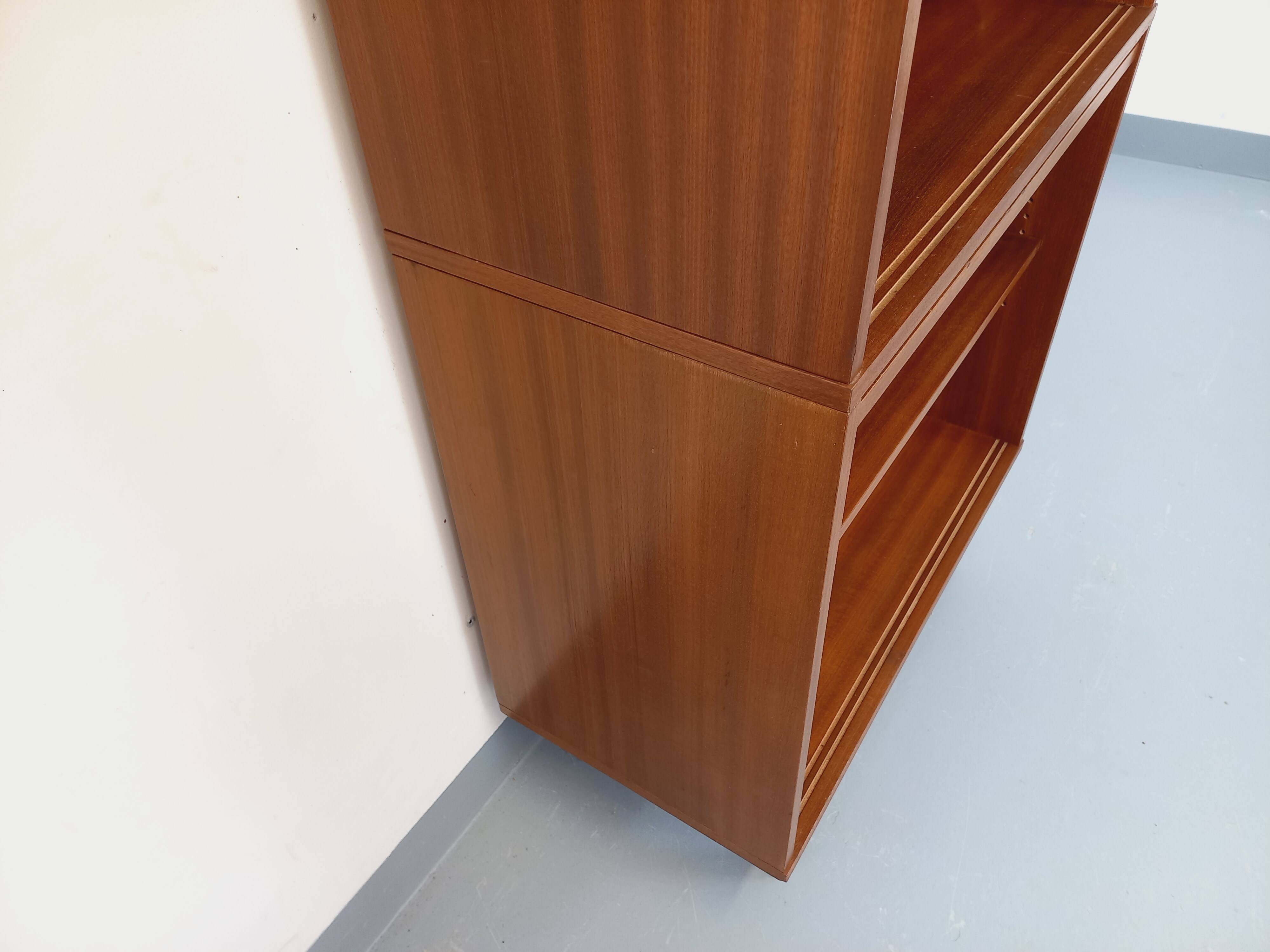 Vintage wooden bookshelf in teak style from the 1960s.