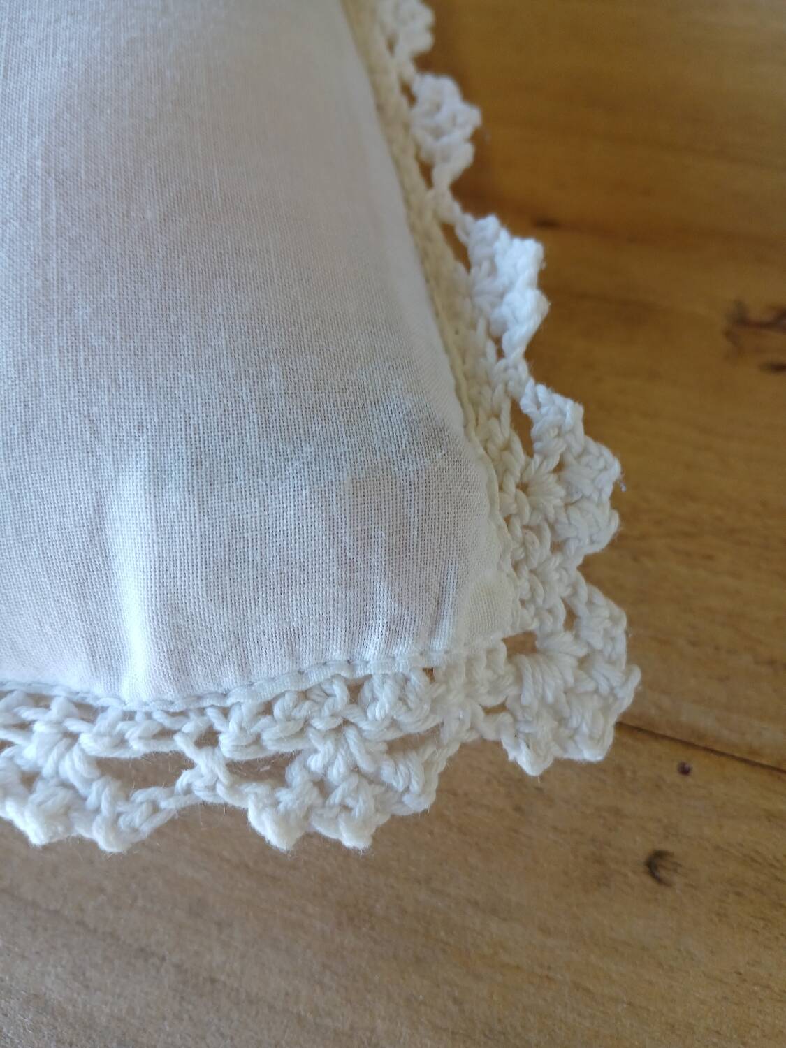 Cushion with white crochet cover