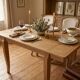 Oak dining table with a checkerboard top and extensions.