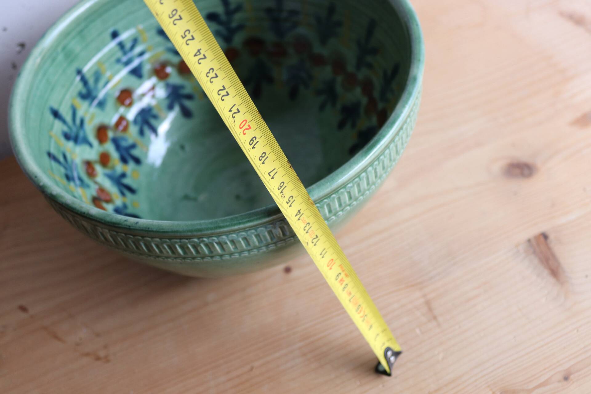 Large glazed ceramic salad bowl with a floral design.