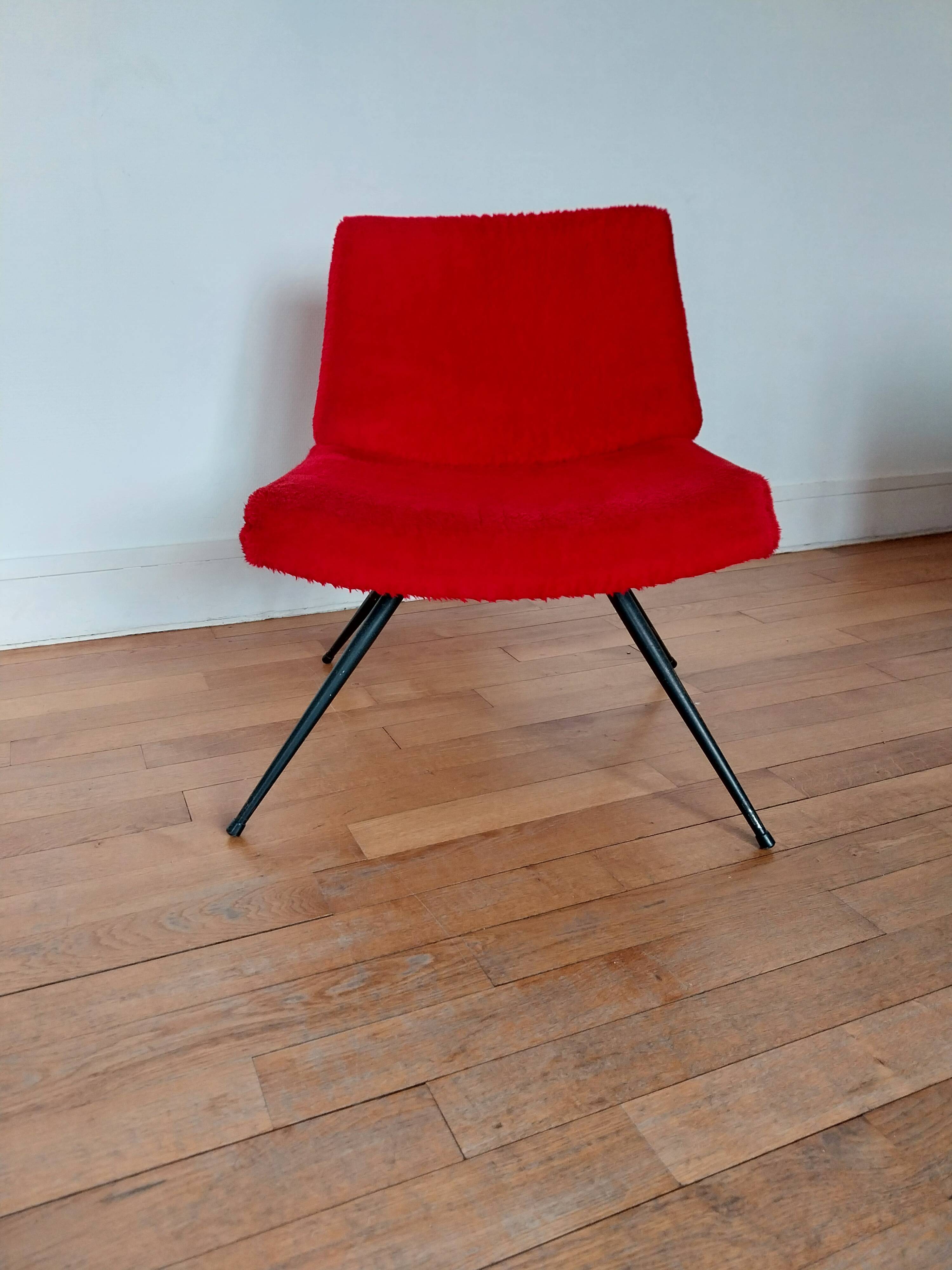 Vintage red faux fur armchair with black metal legs.