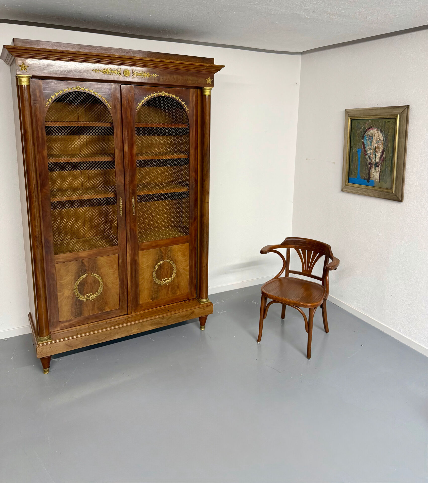 Large Empire-style library in wood with gilded bronze ornaments.