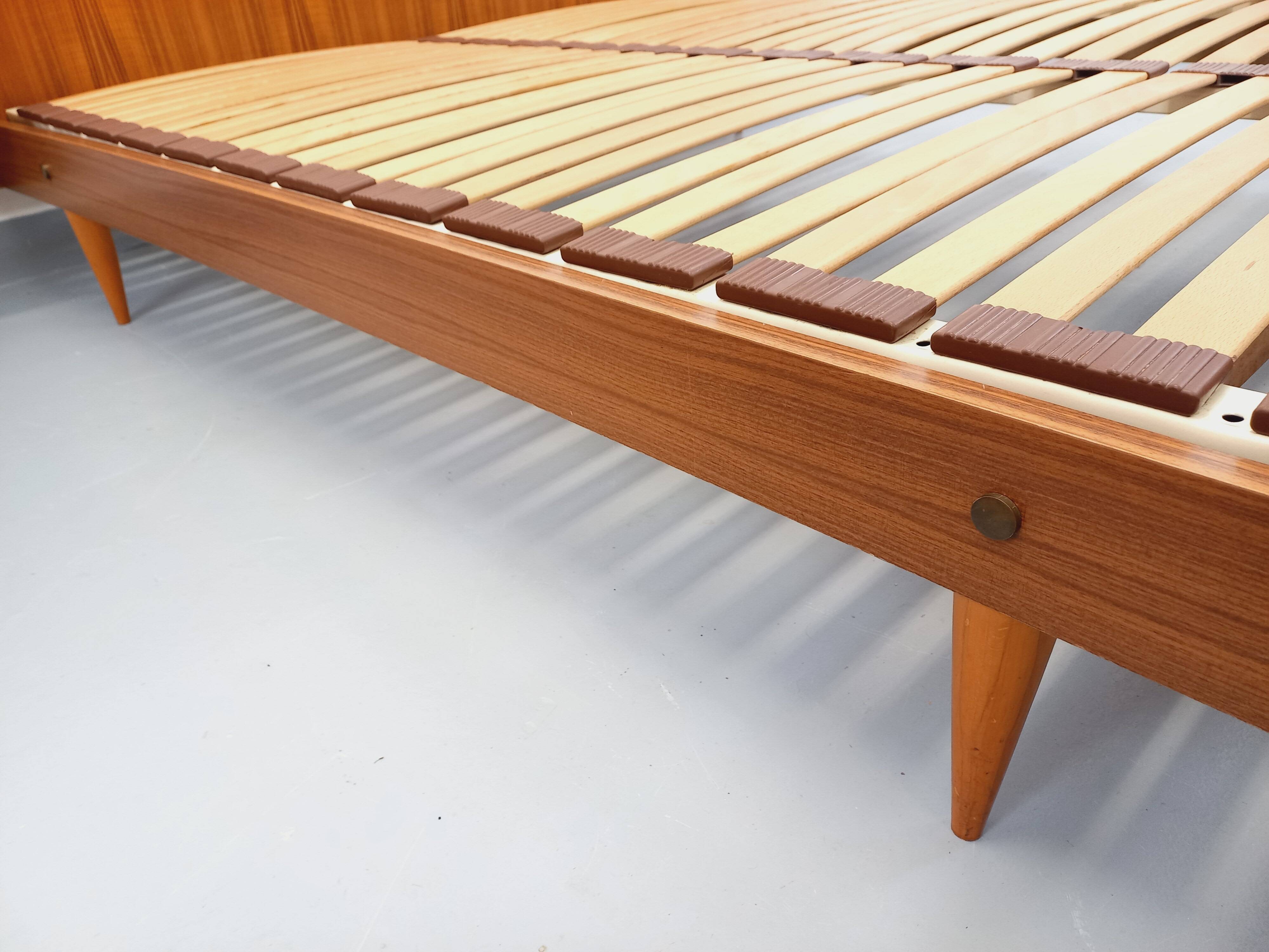 Double bed in vintage Scandinavian style from the 1960s with bedside tables in teak.