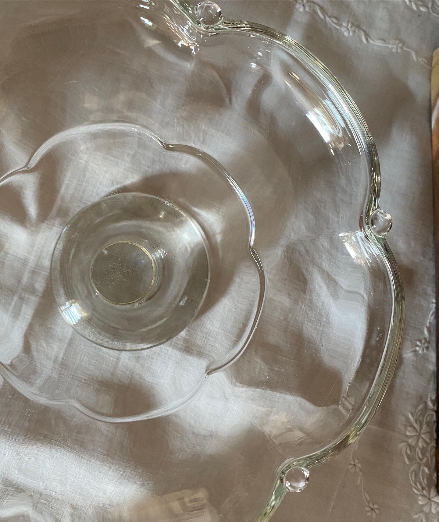 Standing molded glass cup depicting a flower