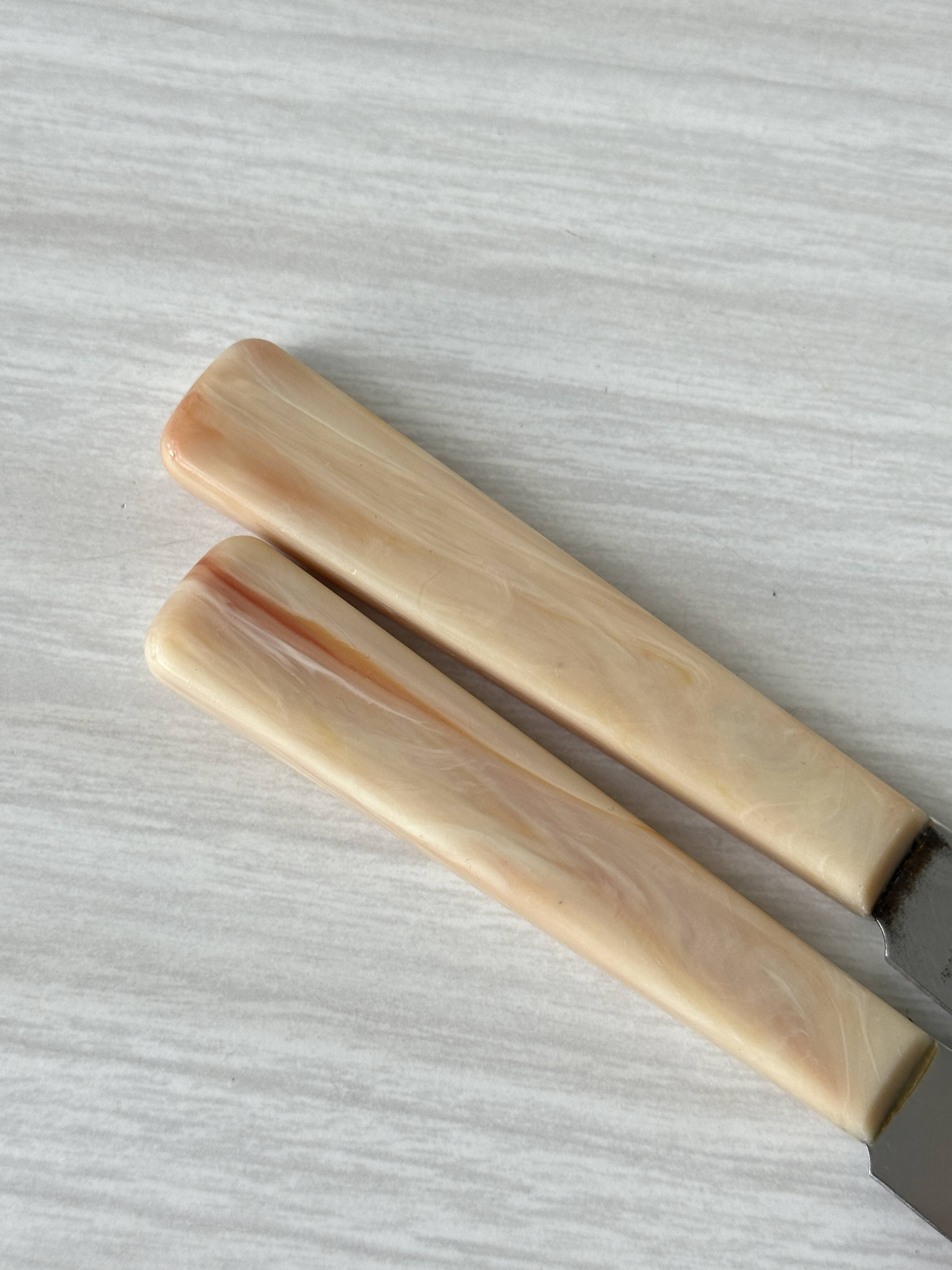 Pink bakelite butter knives.