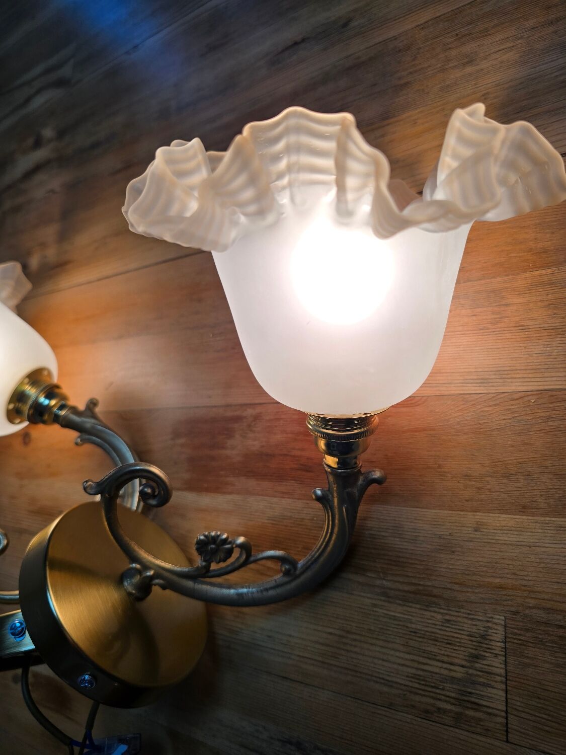 Original and vintage wall sconces, brass arm and lace tulip.