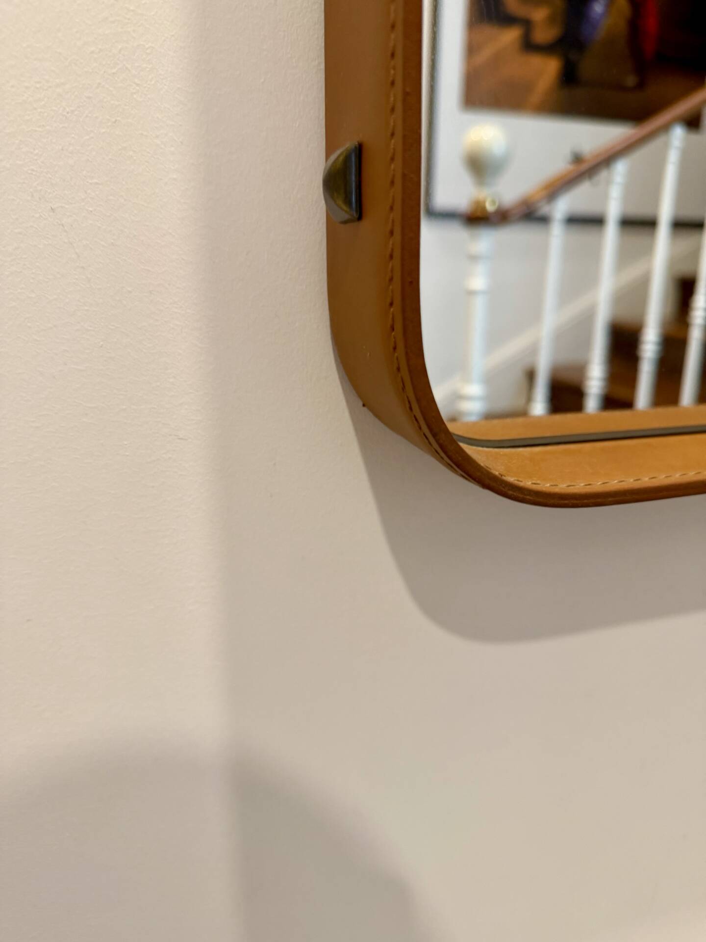 Jacques Adnet mirror covered in cognac leather